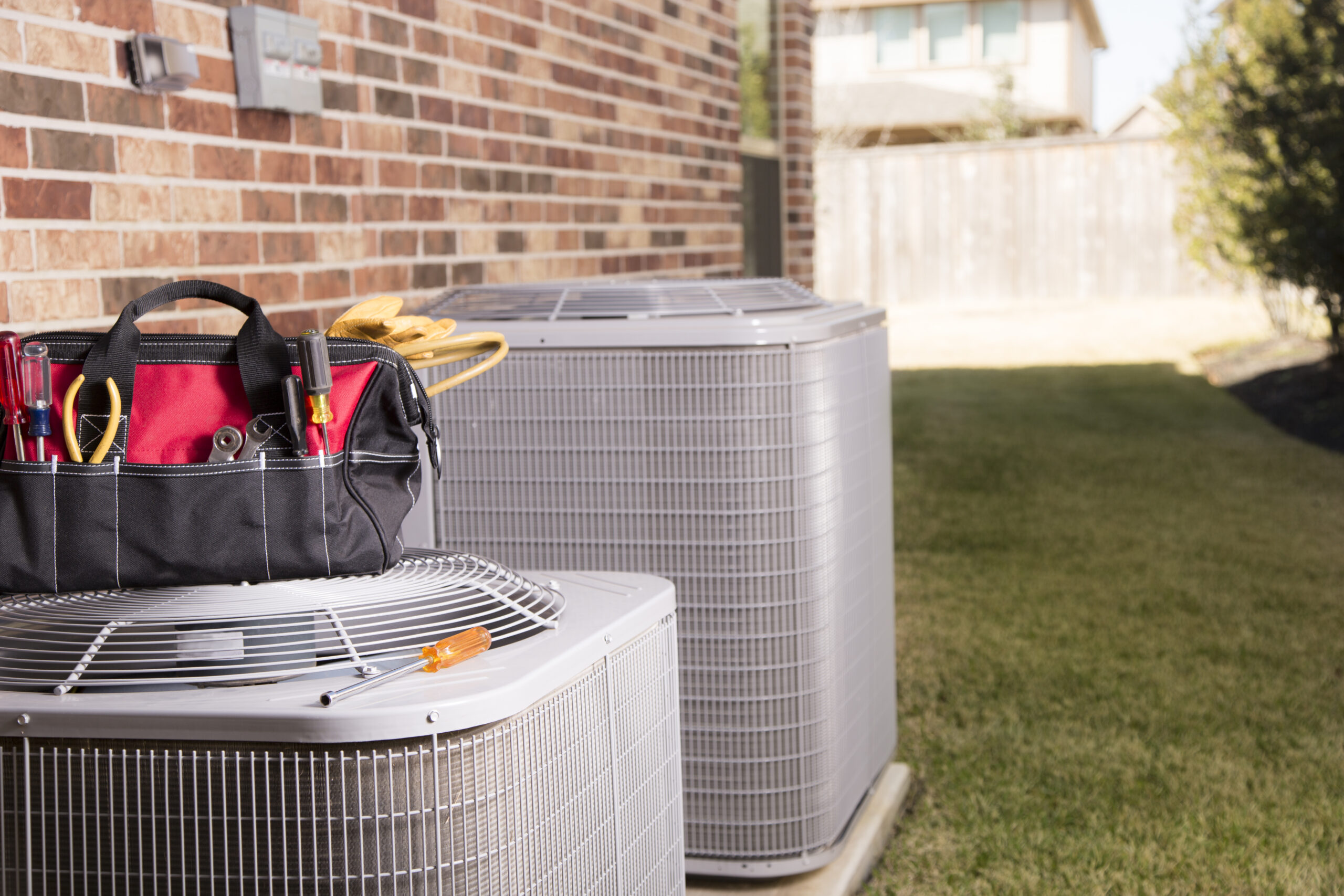 Service Industry: Work tools on air conditioners. Outside home.